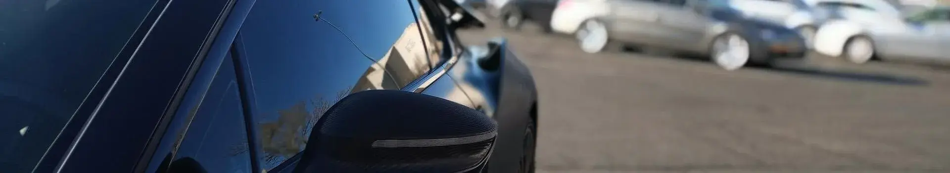 Close up of the side of a black car that is parked