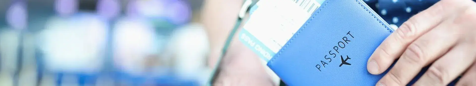 Boarding pass inside passport held by hand