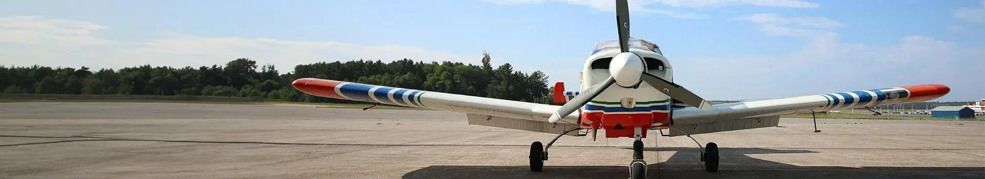 Front view of small prop plane on ground